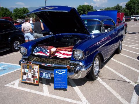 1972 Ford Ranchero - A blue 1957 Chevrolet Bel Air is displayed with its hood open, revealing an American flag and an eagle graphic.