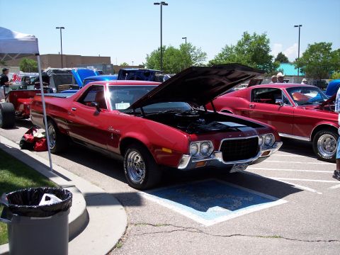 1972 Ford Ranchero - A red 1972 Ford Ranchero is displayed with its hood open at an outdoor event.
