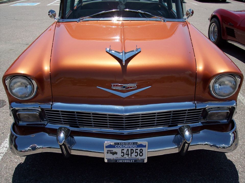 1956 Chevrolet Bel Air front end with chrome grille and bumper, orange metallic paint