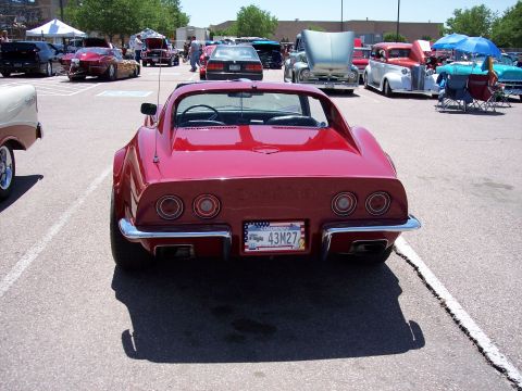 1972 Ford Ranchero - A red 1972 Chevrolet Corvette Stingray is parked at an outdoor event with other vehicles.