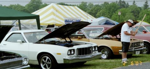 1976 Ford Ranchero - Multiple Ford Rancheros are displayed with hoods open at an outdoor event.