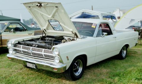 1976 Ford Ranchero - White 1966 Ford Fairlane Ranchero on display with its hood open, next to another vehicle.