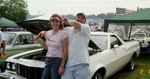 1976 Ford Ranchero - Couple poses with a white 1976 Ford Ranchero at an outdoor car show.