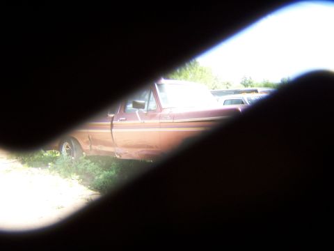 1980 Jeep CJ5 - A side view of a brown pickup truck, possibly a 1979 Ford F-Series, with another vehicle in the background.
