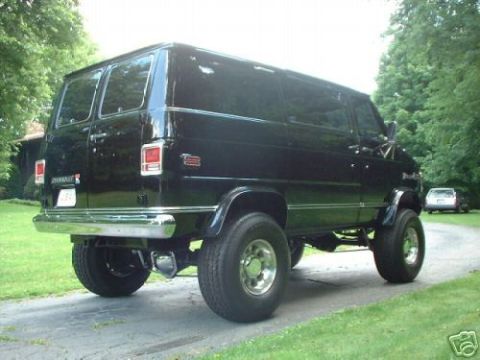 1978 Ford E250 - This black van appears to be from the late 1970s, with a lifted suspension and large tires.