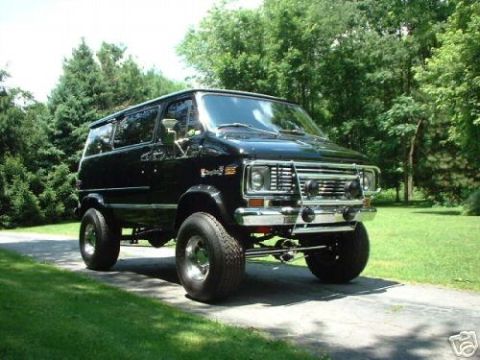 1978 Ford E250 - This lifted 1978 Ford E250 van is shown from a 3/4 front angle on a paved driveway.