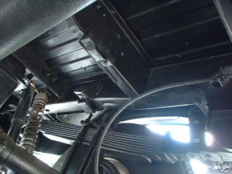 1978 Ford E250 - Undercarriage view showing leaf springs and suspension components.