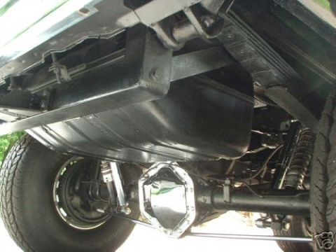 1978 Ford E250 - The underside of a vehicle is visible, with a focus on the fuel tank and rear axle components.