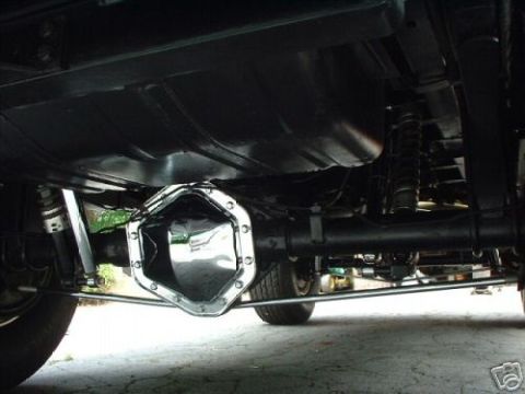 1978 Ford E250 - The underside of a vehicle shows the rear axle, differential, fuel tank, and suspension system.
