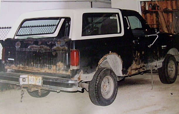 1988 Ford Bronco, rear quarter view, black and white with rust