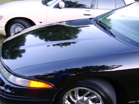 1996 Mercury Grand Marquis - Two sedans parked side-by-side, with the front of a black car in focus.