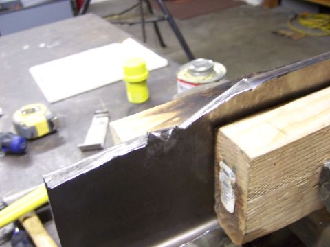 1991 Ford Bronco - Metal part being worked on in a workshop setting.