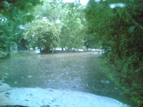 2001 Ford Fiesta - Driving through a flooded area during heavy rain, with water covering the road.