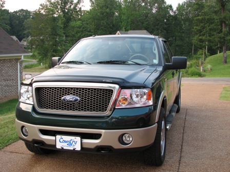 1991 Ford Bronco - Front view of a green 2004 Ford F-150 pickup truck parked on a driveway.