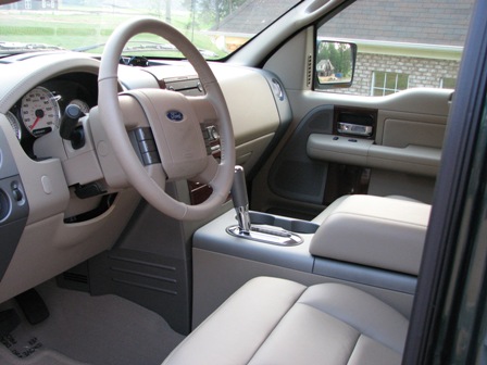 1991 Ford Bronco - The dashboard and interior of a Ford F-150 truck, showing the steering wheel, center console, and seats.
