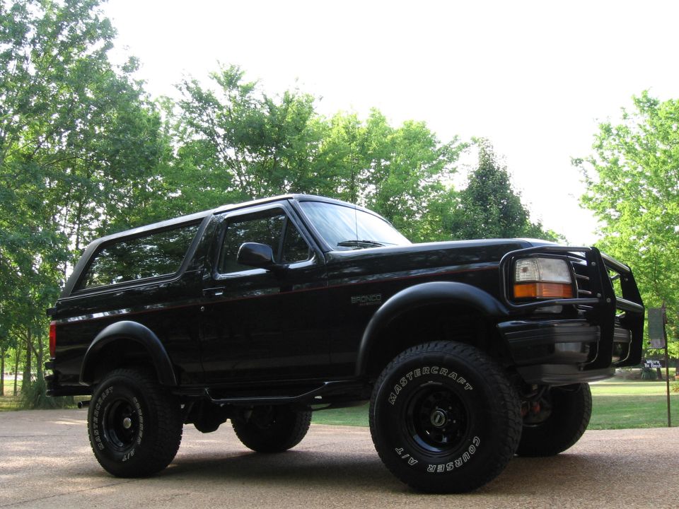 Lifted black full-size Ford Bronco with brush guard and Mastercraft A/T tires