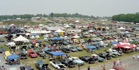 1976 Ford Ranchero - A large gathering of cars and people at an outdoor event, likely a car show or swap meet.