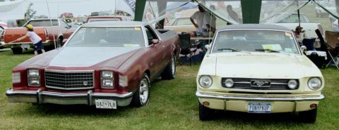 1976 Ford Ranchero - A 1976 Ford Ranchero is shown from the front, parked next to a yellow Ford Mustang at an outdoor event.