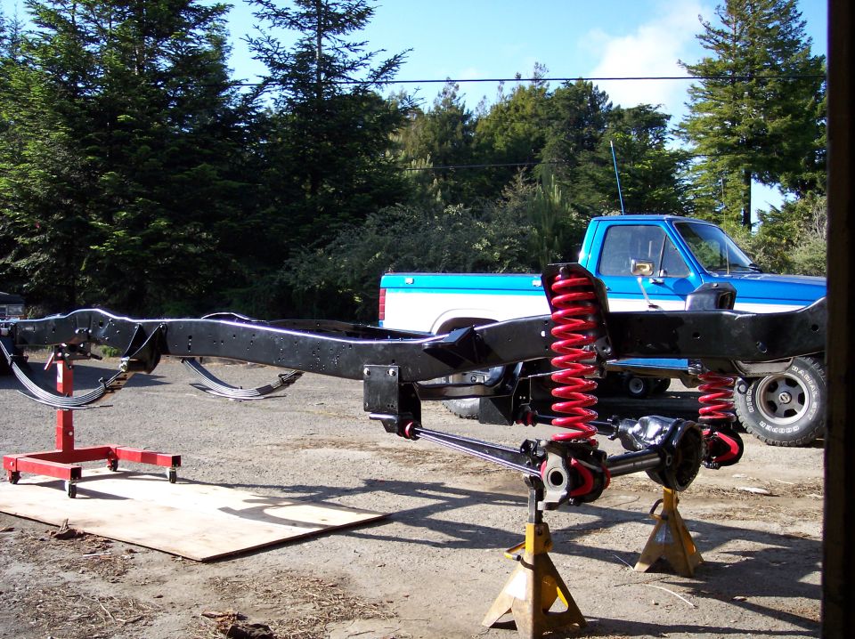 1977 Ford F-150 chassis with red springs on jack stands