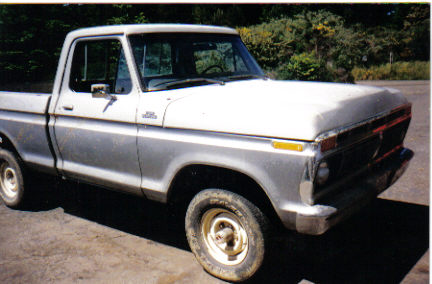 1977 Ford F-150 - This 1977 Ford F-150 pickup truck is shown from the front three-quarter angle, revealing its two-tone paint scheme and weathered condition.