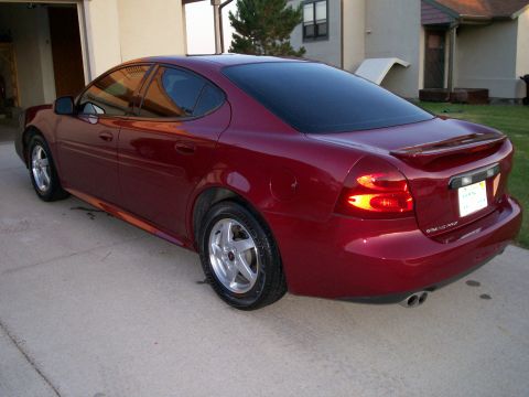2004 Pontiac Grand Prix - Rear view of a dark red 2004 Pontiac Grand Prix GT sedan parked on a driveway.