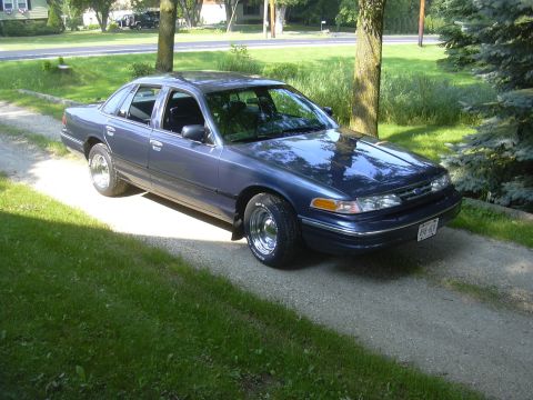 1996 Ford Crown Victoria - Blue 1996 Ford Crown Victoria parked on a gravel driveway.