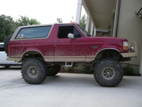 1995 Ford Bronco - This lifted Ford Bronco has a custom bumper and is covered in mud.