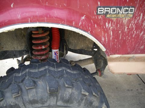 1995 Ford Bronco - Close-up of the fender well on a 1995 Ford Bronco, showing the suspension and a large off-road tire.