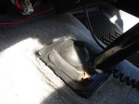 1996 Ford F-150 - Close-up of a vehicle's interior floor area with a rubber boot and wiring visible.