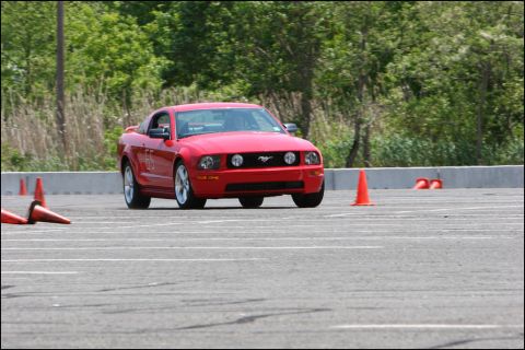2001 Mercury Grand Marquis - A red Ford Mustang navigates an autocross course.