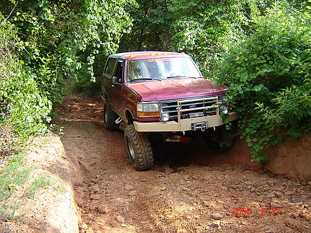 1995 Ford Bronco - This 1995 Ford Bronco navigates a challenging muddy off-road path.