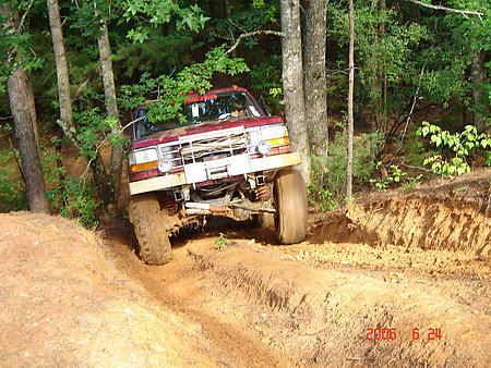 1995 Ford Bronco - Red 1995 Ford Bronco navigates a challenging off-road trail in Barnwell ORV Park.