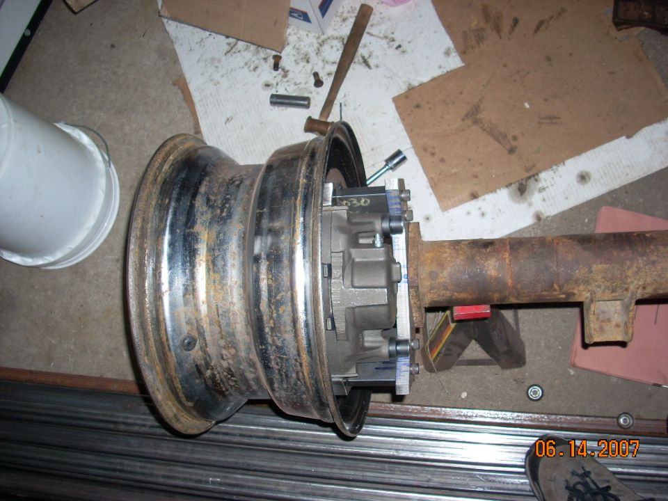 Differential and axle assembly attached to a wheel, with tools and cardboard in the background. Date stamp reads 06-14-2007