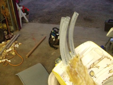 1995 Ford Mustang - A fuel tank with four clear hoses is shown, with various tools and materials in the background.