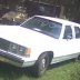 1991 Ford Crown Victoria - A white 1991 Ford Crown Victoria sedan is seen from the front quarter angle, parked outdoors.