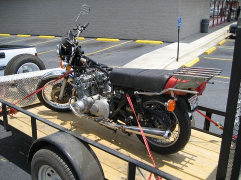 2004 Ford F-150 - A vintage motorcycle is secured to a trailer for transport.