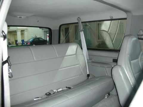1996 Ford Bronco - Rear interior view of a 1996 Ford Bronco, gray leather seats and seatbelts.
