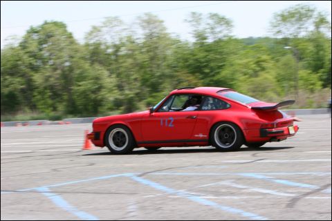 2001 Mercury Grand Marquis - A red Porsche 911 with a large rear spoiler navigates a course marked by cones.