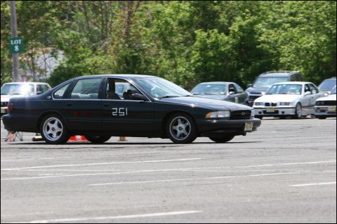 2001 Mercury Grand Marquis - A black sedan with racing number 251 is seen on the track during an event.
