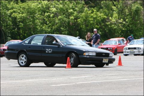 2001 Mercury Grand Marquis - A black sedan with the number 251 on its door navigates an autocross course, with other vehicles visible in the background.