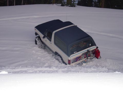 1986 Ford Bronco - This 1986 Ford Bronco is stuck in the snow, showing its rear end and a mounted gas can.