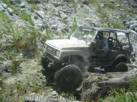 1987 Suzuki Samurai - A Suzuki Samurai tackles a challenging off-road course with a driver behind the wheel.