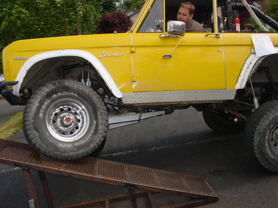 Yellow 1973 Ford Bronco side view on ramp