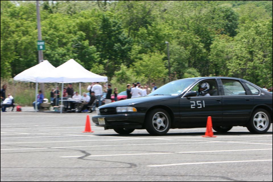 Black sedan with number 251 on door, seen from 3/4 front angle at an autocross event