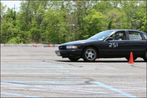 2001 Mercury Grand Marquis - A black sedan with racing numbers navigates a course marked by cones.