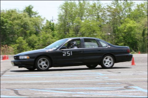 2001 Mercury Grand Marquis - A black sedan with racing number 251 navigates a course marked by orange cones.