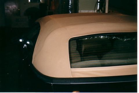 1991 Ford LTD Crown Victoria - Rear quarter view of a black 1991 Ford Crown Victoria with a tan convertible top.