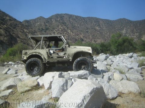 1987 Suzuki Samurai - This Suzuki Samurai navigates a challenging rocky path in a mountainous area.