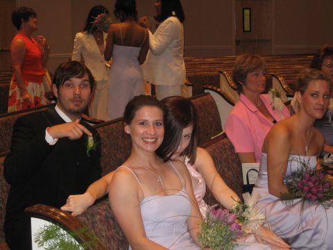 1988 Ford Bronco - Guests attend a wedding ceremony, seated in pews with floral arrangements.