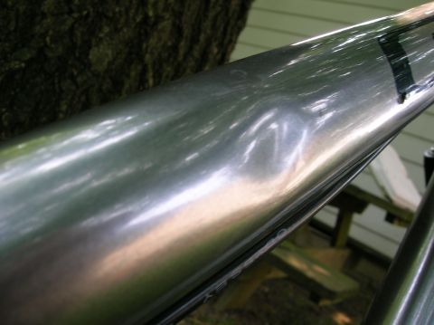 1997 Ford Probe - Close-up of dented chrome trim with faint lettering visible.
